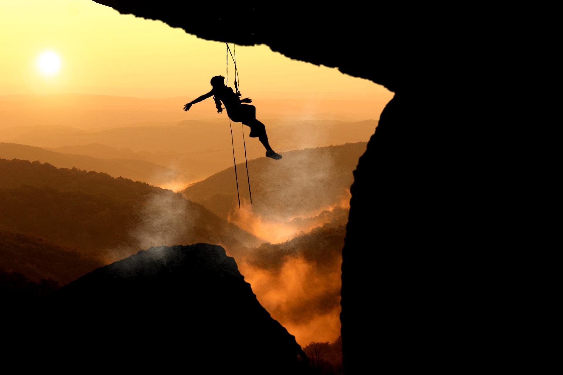 Silhouette of rockclimber hanging under the precipice at sunset.

Discover your path to success!